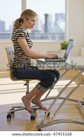 female working on laptop at home office