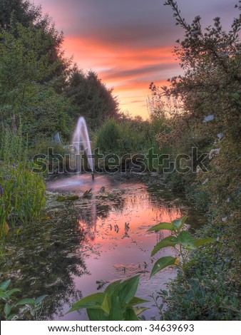 this is a sunset with fountain and garden landscape