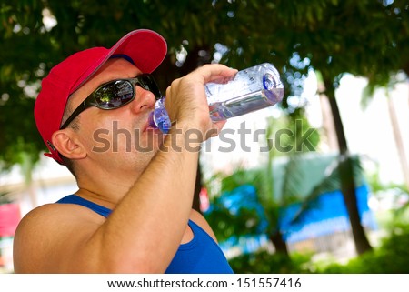 attractive man drink water outdoor