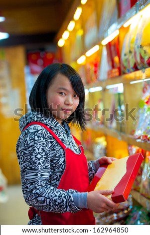 pretty young asian seller in Chinese store