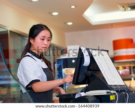 Beautiful Asian Girl Seller In The Coffee Shop