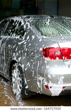 car covered with foam at the car wash place