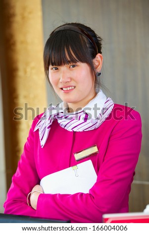 young beautiful asian front desk receptionist indoor hotel
