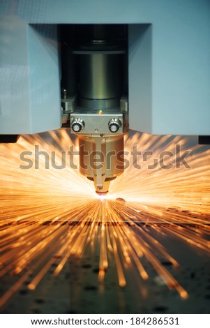 Industrial Laser cutting of steel metal sheet with sparks