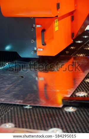 industrial machine cutting steel sheet on factory