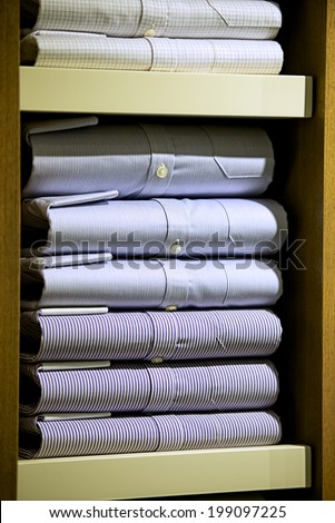 Stacked fashionable mens shirts in retail place