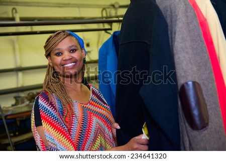 Pretty dry cleaner woman does her job in laundry