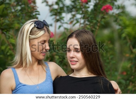 Mom and teenage daughter have talk outdoor photo