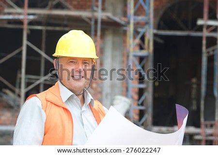 Builder in helmet with a drawing plan photo