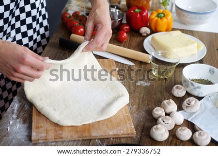 Chef prepare the dough for home made pizza