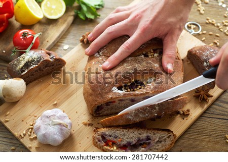 Man sliced organic rural baked rustic rye bread baked with onion