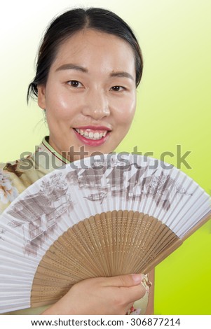 Happy Asian girl with a Chinese fan in the hands