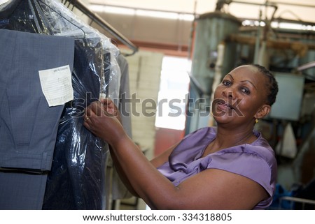 A worker checks cleaning clothes in laundry