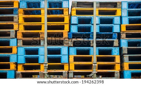 Plastic and wood pallets in color.