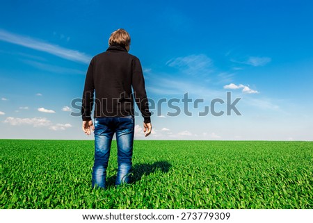 Alone man in corn field is looking forward