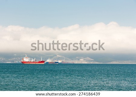 Red ship at anchor in ports water