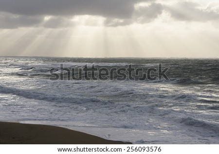 landscape of rough sea with cloudy sky by storm and burst of light