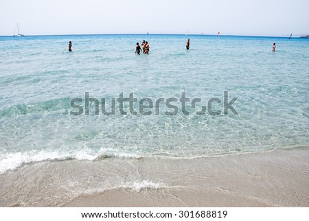 Porto Pino, Italy-AUGUST 06: Unidentified people walking in the sea in summer time on August 06.2012 in Porto Pino, Italy