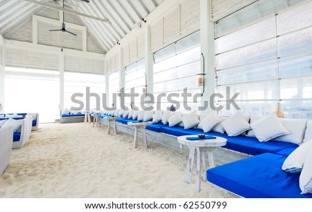 lounge bar on the beach, wooden house interior decorated with white and blue color