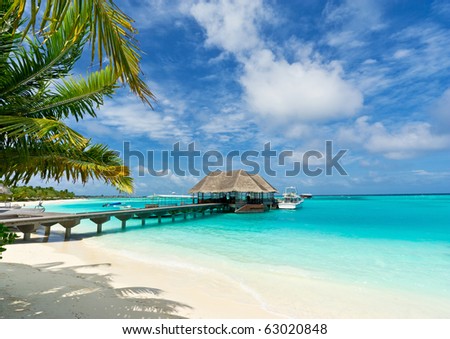 footbridge connecting with the thatched jetty in maldives island resort