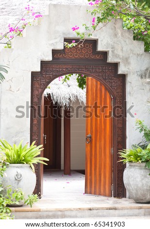 wooden door of the tropical garden villa in beach resort