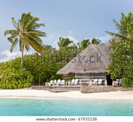 thatched lounge bar on the beach of maldives island resort