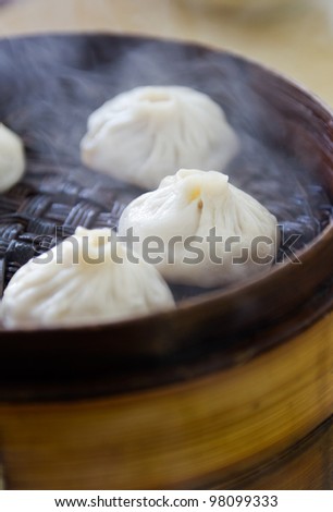 Chinese cuisine, steamed buns with stuffing in the bamboo steamer.