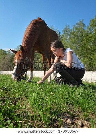 Girl feeding her horse.