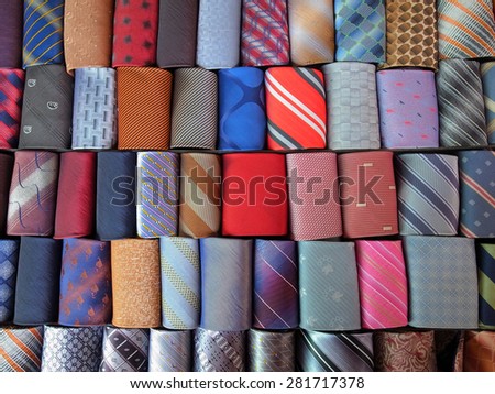 Close up of rolled up neckties.  Shot of a multi-colored collection of rolled-up ties. Colorful ties rolled up and placed in rows.