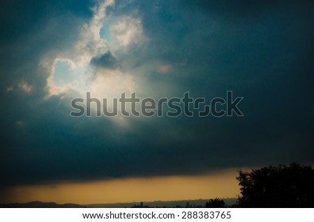 Radiation from behind the clouds. God rays in the sky. Light beams from the sun behind clouds.