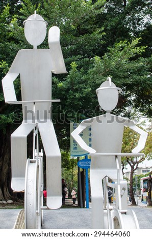Taipei, Taiwan - 22 February 2015: Metal statue of two men riding a bike. Taipei City government encourages citizens to ride bicycles in recent years and the policy is well received.