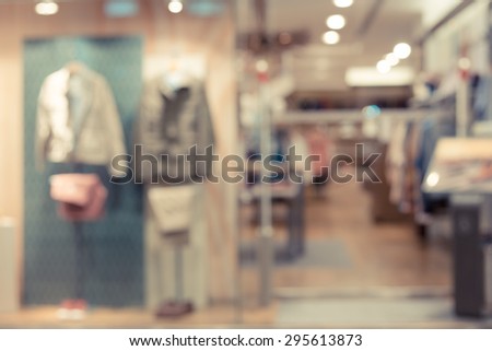 De focused/Blur image of a male dress store with mannequins.