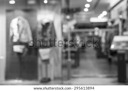Black and white, de focused/blur image of a male dress store with mannequins.