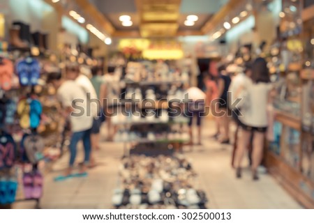 De focused/Blurred image of a shoe store with customers in it.