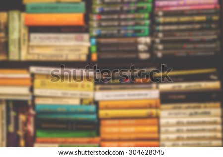 De focused/Blurred image of books on bookshelf. Retro effect.