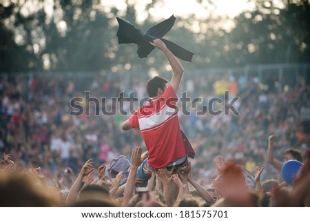 Young man raised by the crowd during a concert
