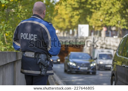 PARIS, FRANCE - OCTOBER 31, 2014 :French policeman controls speed with a mobile radar Pro laser 4