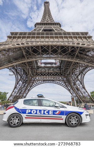 PARIS, FRANCE - APRIL 26, 2015 : French car police parked in front of Eiffel tower (Tour Eiffel) because of plan Vigipirate, plan against attack terrorist