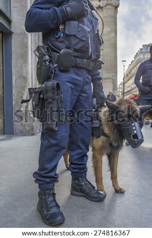 PARIS, FRANCE - JANUARY 11, 2015 : French Police dog trainer patrolling for plan vigipirate against attack terrorist