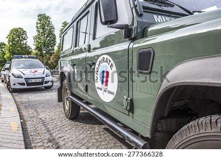 PARIS, FRANCE - MAY 12, 2015 : French army car and Police car parked in the street to patrol for Plan Vigipirate (France's national security alert system) against possible terrorist attacks.