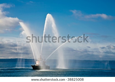 A fireboat casting water stream at open water