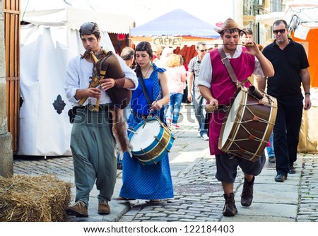 CAMINHA - JULY 14: A group of musicians in medieval clothes, playing in the street During The Medieval Fair celebrated in Caminha, Portugal on July 14, 2012 in Caminha, Portugal