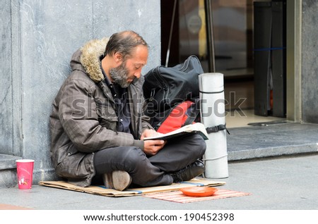 BILBAO, SPAIN - APRIL 4, 2014: A man begging, sitting on a street in the Basque city of Bilbao.