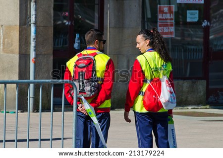 PONTEVEDRA, SPAIN - MAY 31, 2014: Members of Civil Protection watching the course of participating in the World Duathlon Championships.