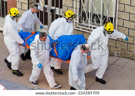 PONTEVEDRA, SPAIN - JUNE 17, 2014: A group of firefighters during an operation to rescue the corpse of a migrant found dead of natural causes at his home.