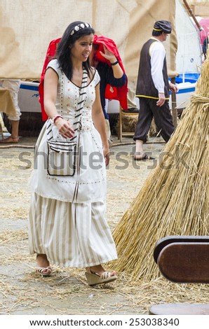 PONTEVEDRA, SPAIN - SEPTEMBER 6, 2014: A woman dressed in medieval dress in medieval festival held each year in the historical district of the city.