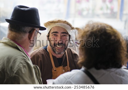 PONTEVEDRA, SPAIN - SEPTEMBER 6, 2014: A man dressed in vintage clothes smiling at the camera, in medieval festival held each year in the historical district of the city.