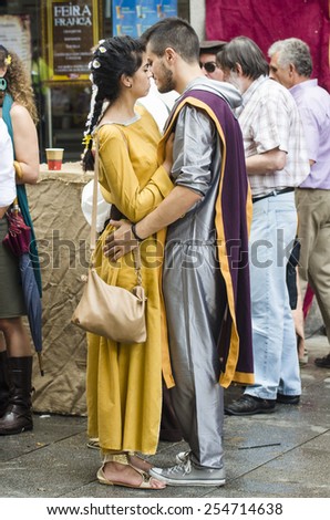 PONTEVEDRA, SPAIN - SEPTEMBER 6, 2014: A couple in love with vintage dress in medieval festival held each year in the historical district of the city.