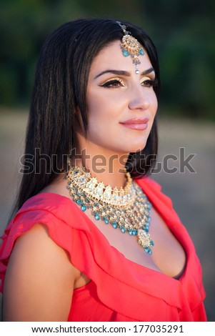 Beautiful Indian Woman in a Sari Smiling and dancing Outdoors. Woman greeting in mekhla. Girl bollywood dancer. Indian Bride with traditional makeup and jewelry. Series.
