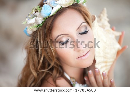 Fantasy makeup woman with shell wreath, mermaid girl with seashell. Fairy sea nymph.  Ocean Goddess.